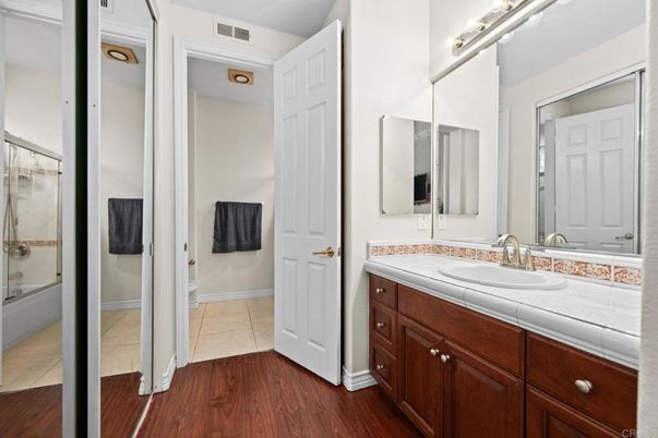 Bathroom, Dual Sink Vanities, Glass Shower, Interior, Tile Countertops, Wood Texture Flooring