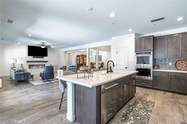 Dining room, Fireplace, Interior, Kitchen, Living room, Recessed Lighting, Stainless Steel Appliances, Wood Texture Flooring