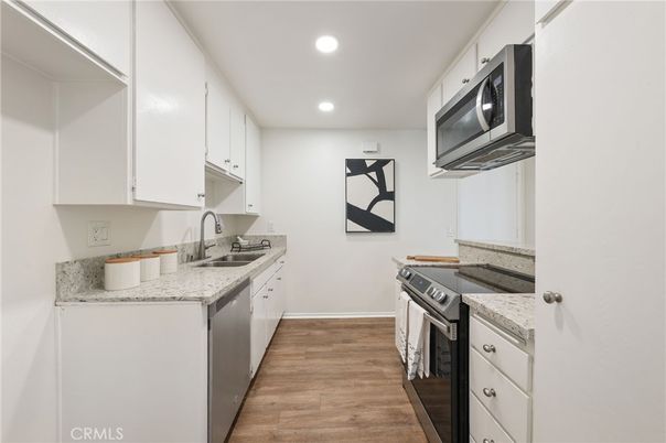 Interior, Kitchen, Recessed Lighting, Washer, Wood Texture Flooring