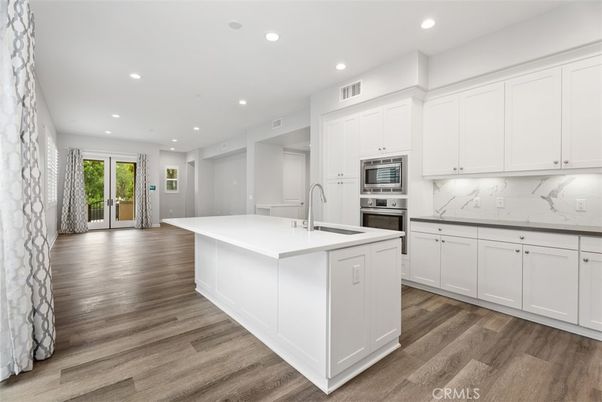 Interior, Kitchen, Marble Walls, Recessed Lighting, Stainless Steel Appliances, Wood Texture Flooring