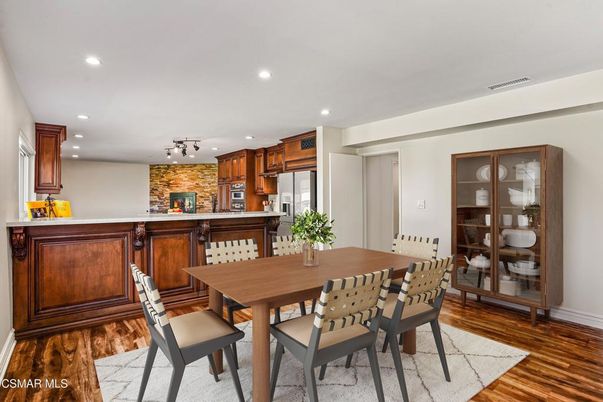 Dining room, Fireplace, Interior, Kitchen, Recessed Lighting, Stainless Steel Appliances, Stone Walls, Wood Texture Flooring