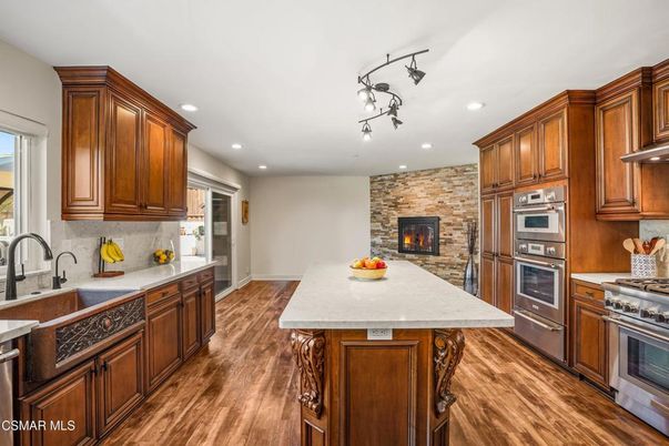 Fireplace, Interior, Kitchen, Recessed Lighting, Stainless Steel Appliances, Stone Walls, Wood Texture Flooring