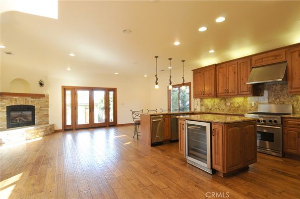 Dining room, Fireplace, Interior, Kitchen, Pendant Lights, Recessed Lighting, Stainless Steel Appliances, Wood Texture Flooring