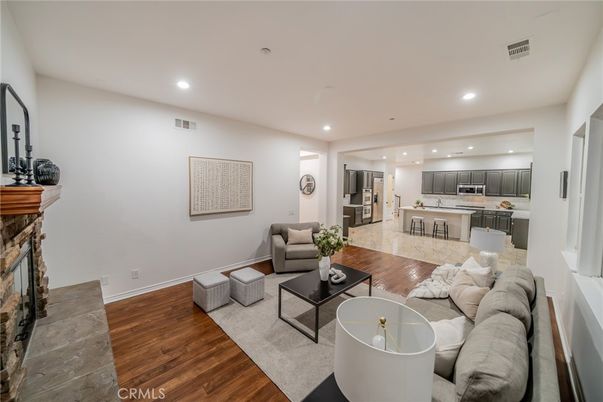 Fireplace, Interior, Kitchen, Living room, Recessed Lighting, Stainless Steel Appliances, Wood Texture Flooring