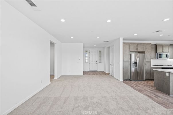 Empty room, Interior, Kitchen, Recessed Lighting, Stainless Steel Appliances, Wood Texture Flooring