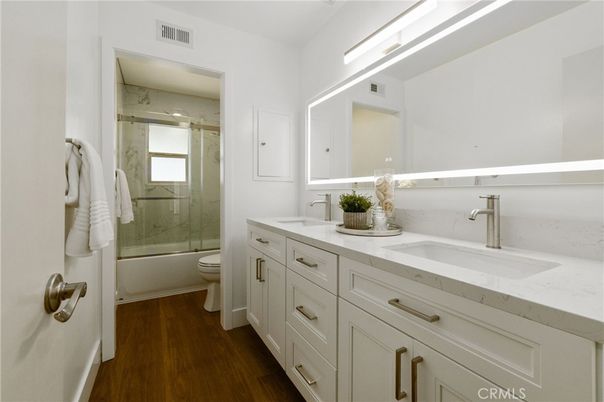 Bathroom, Dual Sink Vanities, Glass Shower, Interior, Marble Walls, Wood Texture Flooring