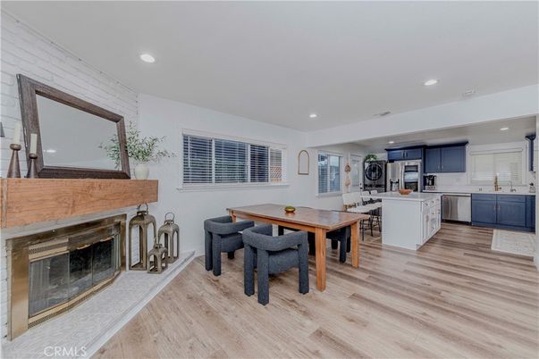 Dining room, Fireplace, Interior, Kitchen, Recessed Lighting, Stainless Steel Appliances, Wood Texture Flooring