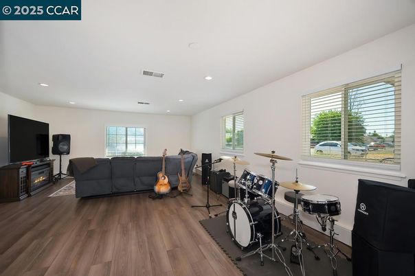Fireplace, Fitness Equipment, Interior, Living room, Recessed Lighting, Wood Texture Flooring