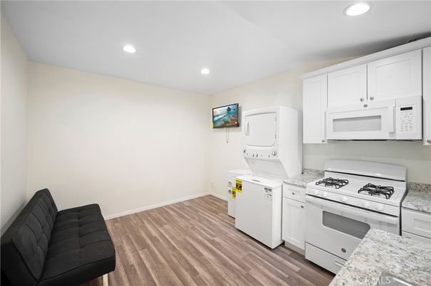 Interior, Kitchen, Recessed Lighting, Washer, Wood Texture Flooring