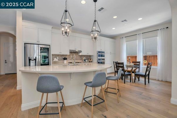 Dining room, Interior, Kitchen, Pendant Lights, Recessed Lighting, Stainless Steel Appliances, Wood Texture Flooring