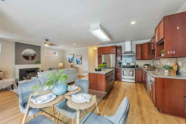 Dining room, Fireplace, Interior, Kitchen, Living room, Recessed Lighting, Stainless Steel Appliances, Wood Texture Flooring