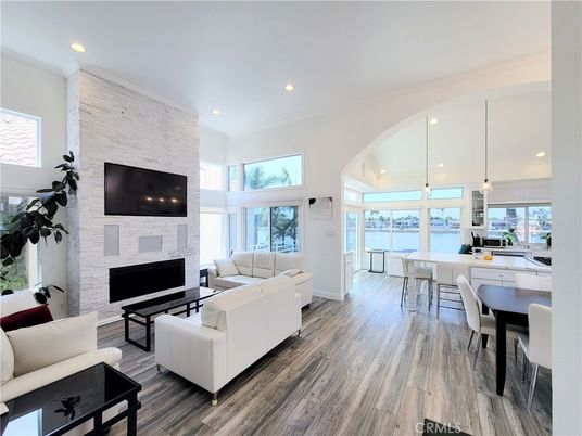 Dining room, Fireplace, Interior, Living room, Pendant Lights, Recessed Lighting, Stone Walls, Water, Wood Texture Flooring