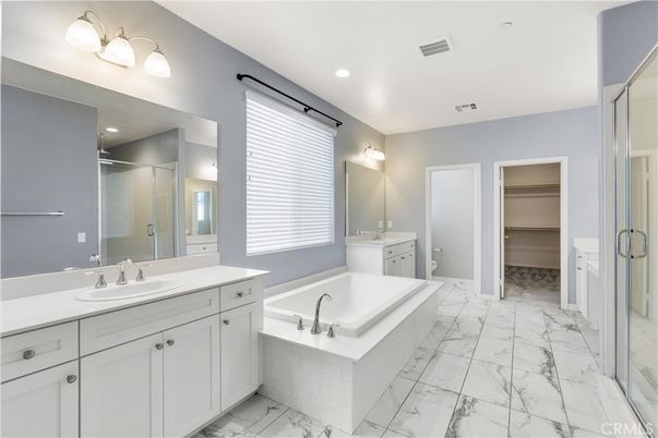 Bathroom, Dual Sink Vanities, Glass Shower, Interior, Marble, Recessed Lighting, Walk-in Closets