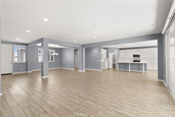 Chandelier, Empty room, Interior, Kitchen, Pendant Lights, Recessed Lighting, Stainless Steel Appliances, Wood Texture Flooring