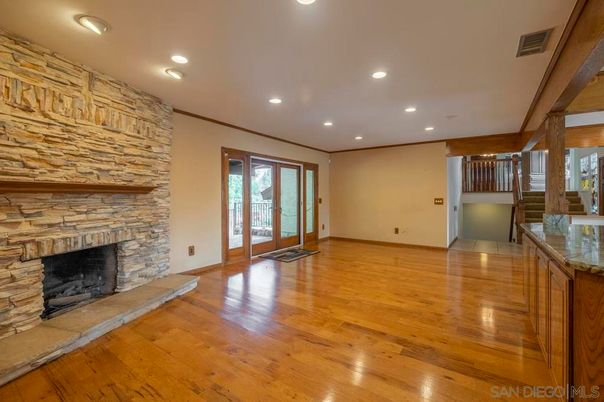 Empty room, Fireplace, Interior, Recessed Lighting, Stone Walls, Wood Texture Flooring