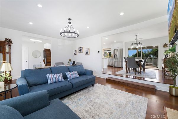 Chandelier, Dining room, Interior, Kitchen, Living room, Pendant Lights, Recessed Lighting, Stainless Steel Appliances, Wood Texture Flooring