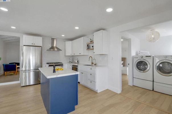 Interior, Kitchen, Recessed Lighting, Stainless Steel Appliances, Washer, Wood Texture Flooring
