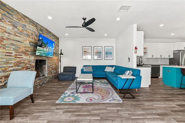 Fireplace, Interior, Kitchen, Living room, Recessed Lighting, Stainless Steel Appliances, Stone Walls, Wood Texture Flooring