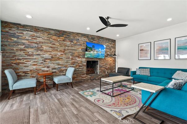 Fireplace, Interior, Living room, Recessed Lighting, Stone Walls, Wood Texture Flooring