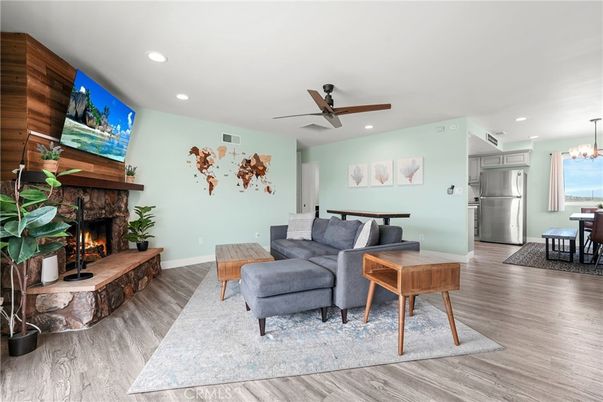 Chandelier, Dining room, Fireplace, Interior, Kitchen, Living room, Recessed Lighting, Stainless Steel Appliances, Wood Texture Flooring