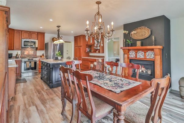 Chandelier, Dining room, Fireplace, Interior, Kitchen, Recessed Lighting, Stainless Steel Appliances, Wood Texture Flooring