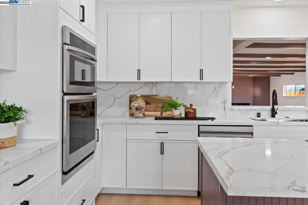 Interior, Kitchen, Marble Walls, Recessed Lighting, Stainless Steel Appliances, Wood Texture Flooring