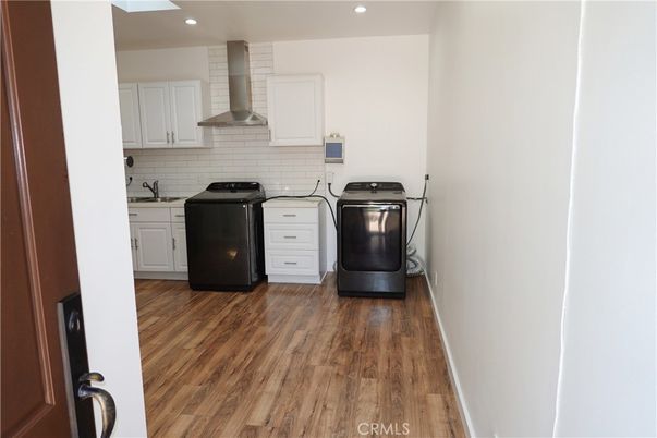 Interior, Kitchen, Recessed Lighting, Washer, Wood Texture Flooring