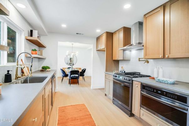 Chandelier, Dining room, Interior, Kitchen, Pendant Lights, Recessed Lighting, Stainless Steel Appliances, Wood Texture Flooring