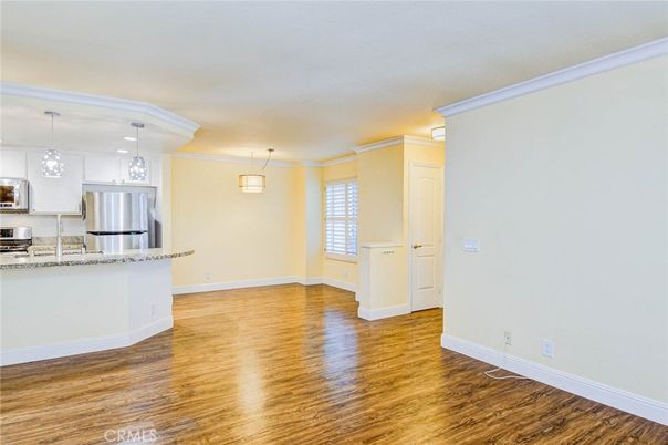 Empty room, Interior, Kitchen, Pendant Lights, Recessed Lighting, Stainless Steel Appliances, Wood Texture Flooring