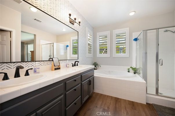 Bathroom, Dual Sink Vanities, Glass Shower, Interior, Recessed Lighting, Tile Countertops, Wood Texture Flooring