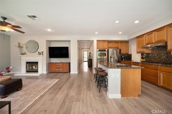 Fireplace, Interior, Kitchen, Living room, Recessed Lighting, Stainless Steel Appliances, Wood Texture Flooring