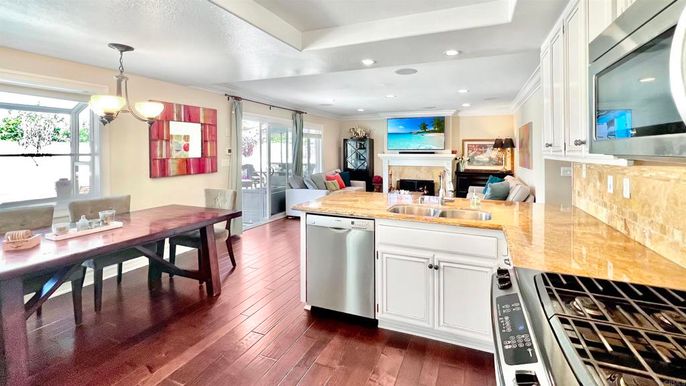 Dining room, Fireplace, Interior, Kitchen, Pendant Lights, Recessed Lighting, Stainless Steel Appliances, Wood Texture Flooring