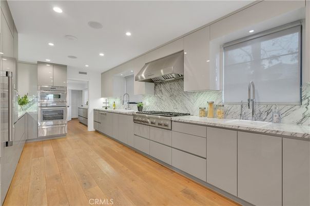 Interior, Kitchen, Marble Walls, Recessed Lighting, Stainless Steel Appliances, Wood Texture Flooring