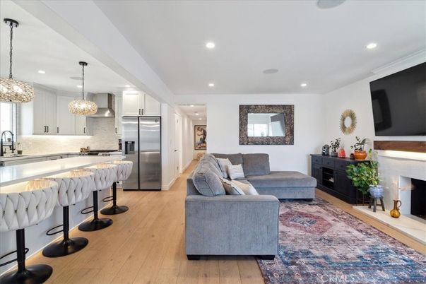 Fireplace, Interior, Kitchen, Living room, Pendant Lights, Recessed Lighting, Stainless Steel Appliances, Wood Texture Flooring