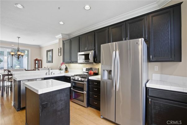 Chandelier, Dining room, Interior, Kitchen, Pendant Lights, Recessed Lighting, Stainless Steel Appliances, Tile Countertops, Wood Texture Flooring