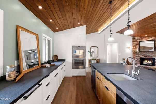 Fireplace, Interior, Kitchen, Pendant Lights, Recessed Lighting, Stainless Steel Appliances, Stone Walls, Wooden Ceilings, Wood Texture Flooring