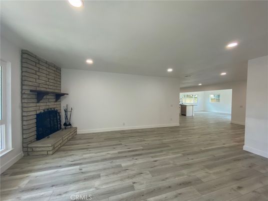 Empty room, Fireplace, Interior, Recessed Lighting, Stone Walls, Wood Texture Flooring