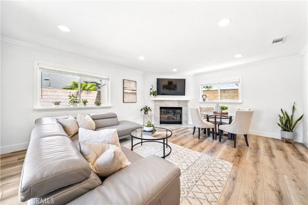Dining room, Fireplace, Interior, Living room, Recessed Lighting, Wood Texture Flooring