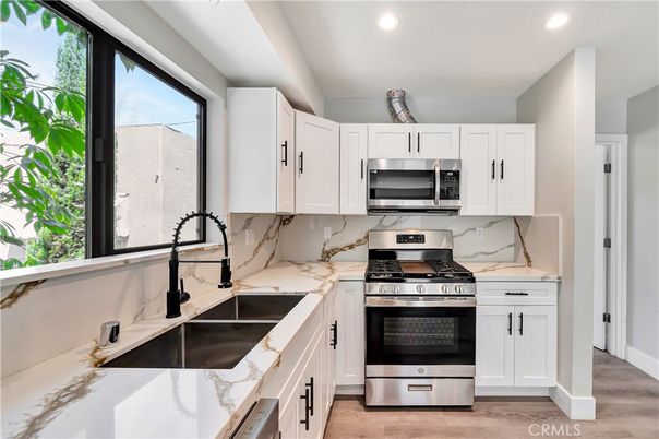 Interior, Kitchen, Marble Walls, Recessed Lighting, Stainless Steel Appliances, Wood Texture Flooring
