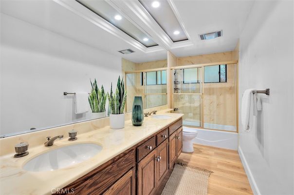Bathroom, Dual Sink Vanities, Glass Shower, Interior, Recessed Lighting, Wood Texture Flooring