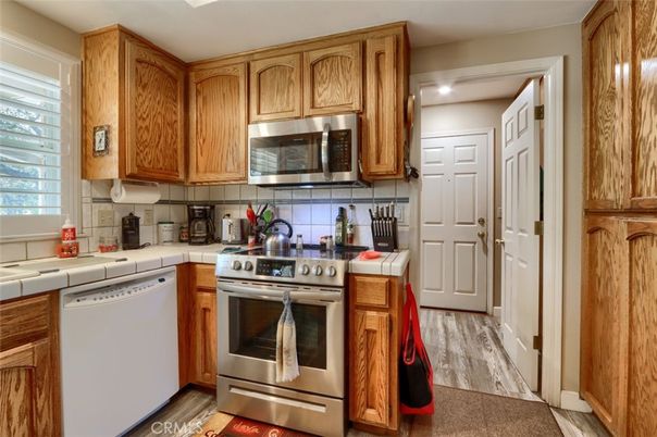 Interior, Kitchen, Recessed Lighting, Stainless Steel Appliances, Tile Countertops, Wood Texture Flooring