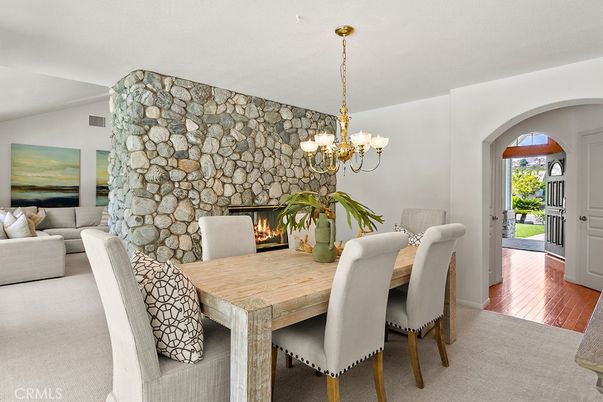 Chandelier, Dining room, Fireplace, Interior, Living room, Stone Walls, Wood Texture Flooring
