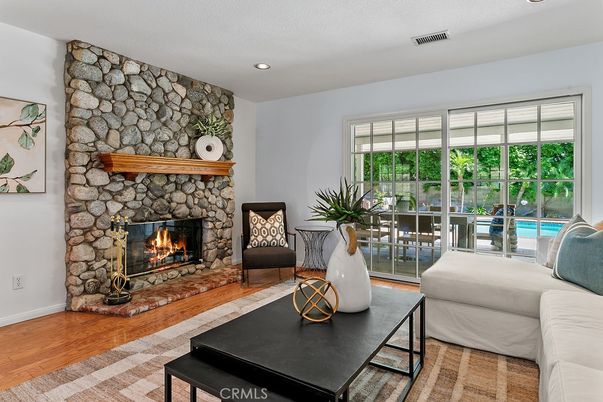 Fireplace, Interior, Living room, Recessed Lighting, Stone Walls, Wood Texture Flooring
