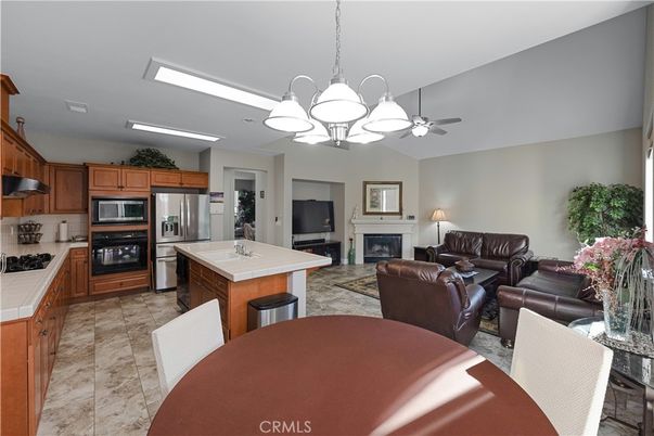 Chandelier, Dining room, Fireplace, Interior, Kitchen, Living room, Stainless Steel Appliances