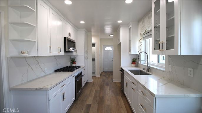 Interior, Kitchen, Marble Walls, Recessed Lighting, Stainless Steel Appliances, Wood Texture Flooring