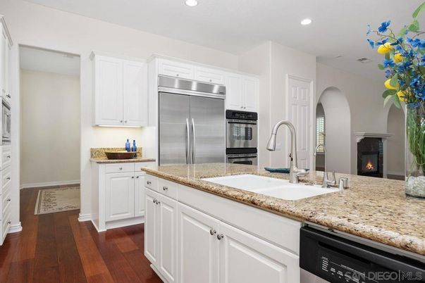 Fireplace, Interior, Kitchen, Recessed Lighting, Stainless Steel Appliances, Wood Texture Flooring