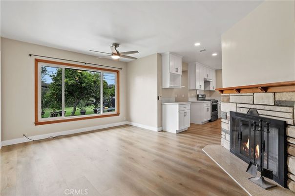 Empty room, Fireplace, Interior, Kitchen, Recessed Lighting, Washer, Wood Texture Flooring