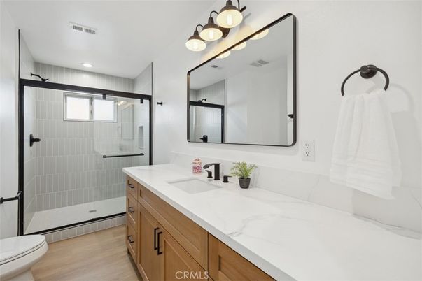 Bathroom, Dual Sink Vanities, Glass Shower, Interior, Recessed Lighting, Wood Texture Flooring