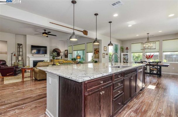 Dining room, Fireplace, Interior, Kitchen, Living room, Pendant Lights, Recessed Lighting, Stainless Steel Appliances, Wood Texture Flooring