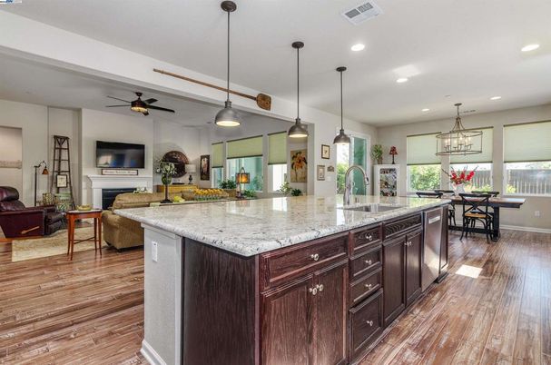 Dining room, Fireplace, Interior, Kitchen, Living room, Pendant Lights, Recessed Lighting, Stainless Steel Appliances, Wood Texture Flooring